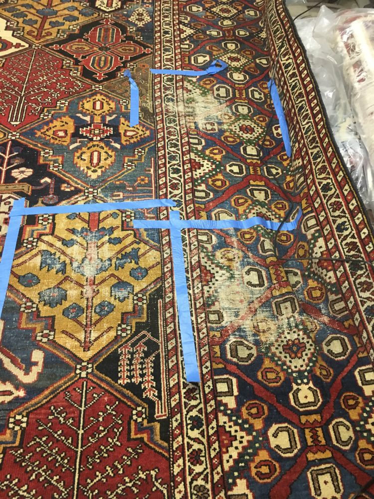 Antique Bakhtiari rug with worn areas marked with tape