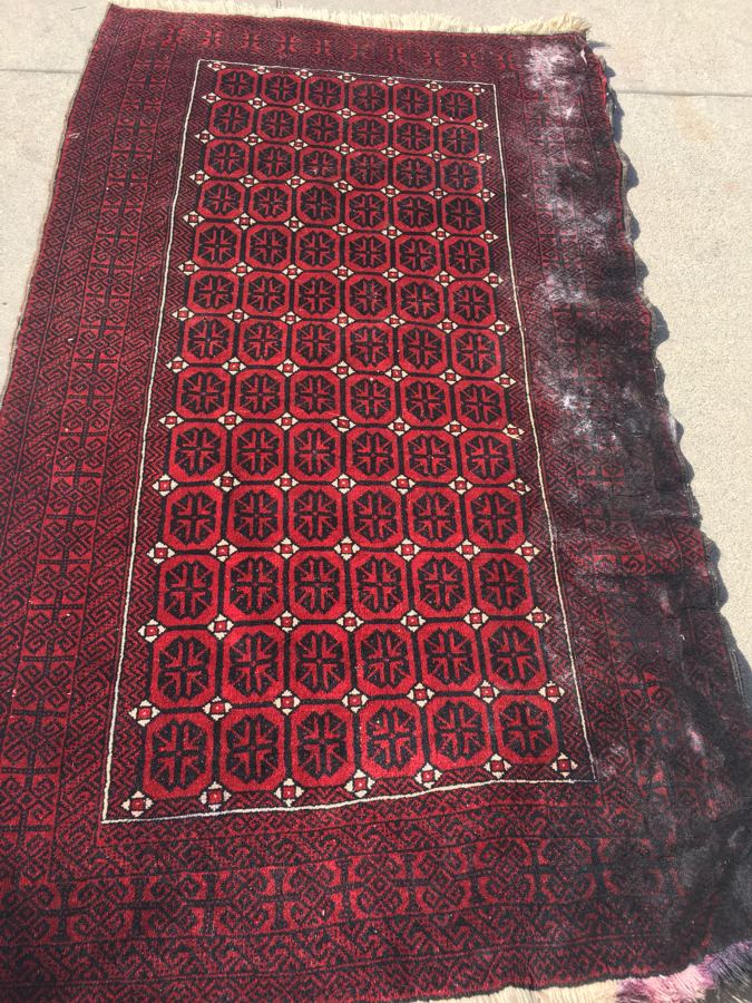 Baluch rug with mold damage along one side