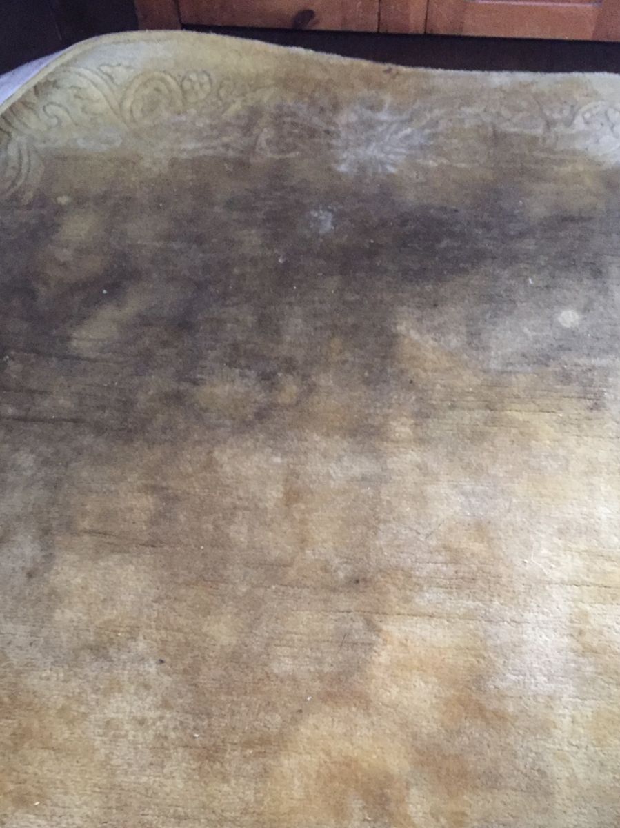 Hand-carved gold rug with heavy dark staining