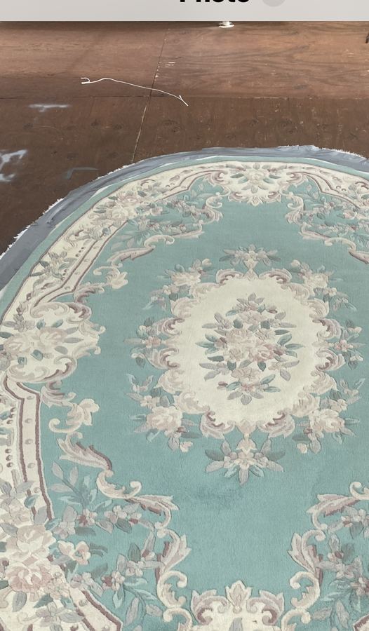 Oval Chinese rug with faded pile before shearing