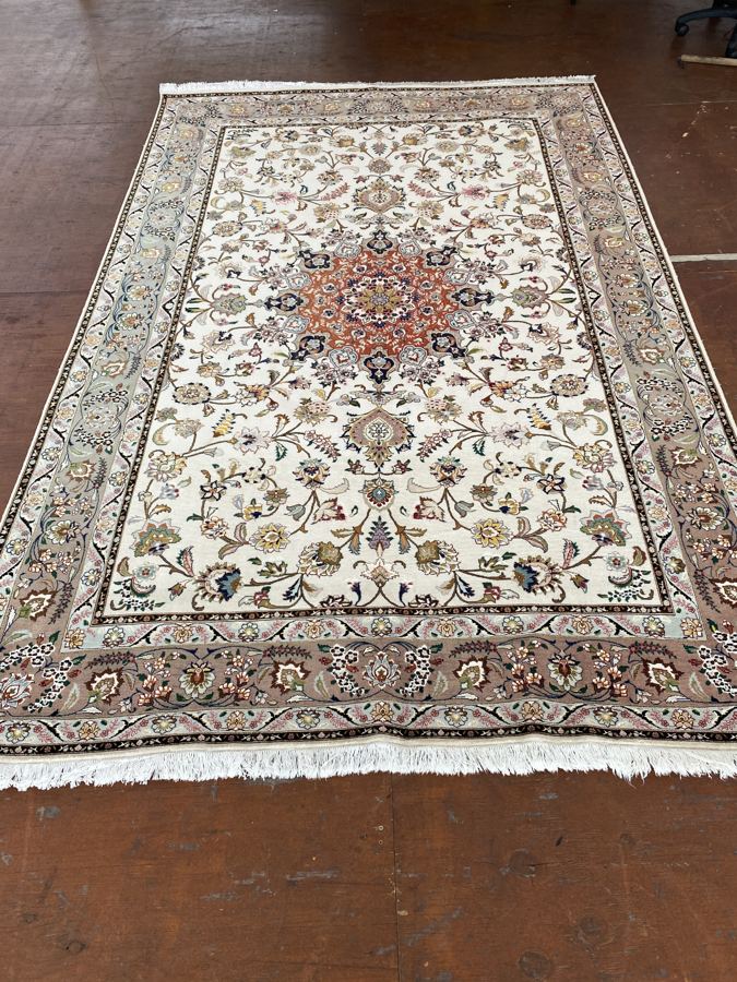 Ivory Tabriz rug with a faded border before shearing